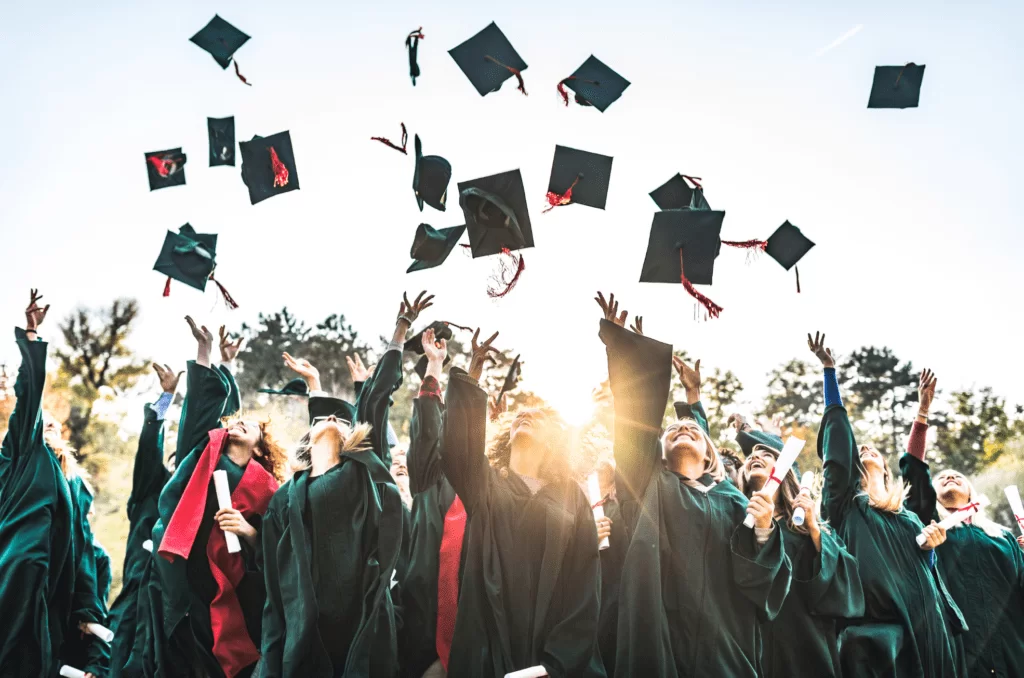 students throw their hats at graduation celebration