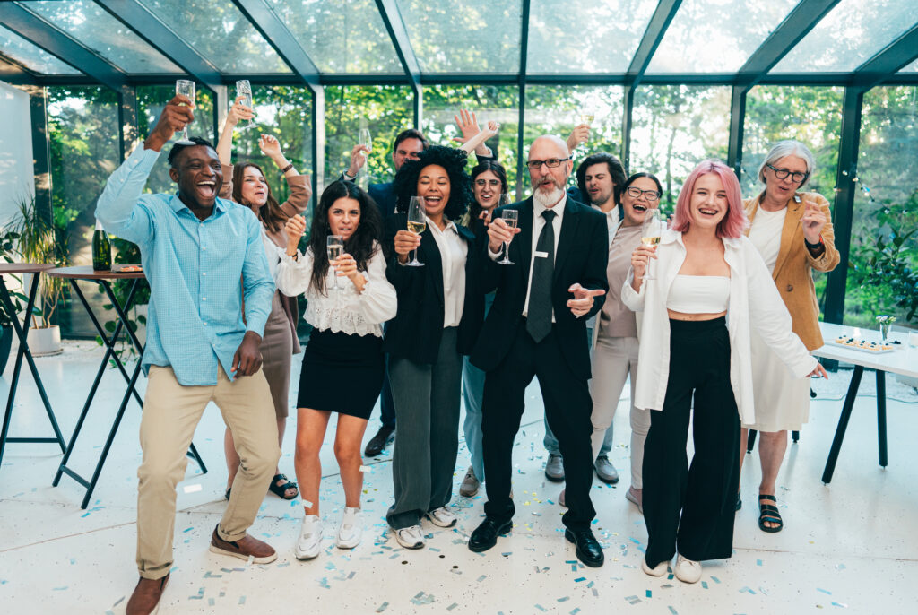 Businessmen and businesswomen making a corporate party after the business conference to celebrate the year goals and achievements.