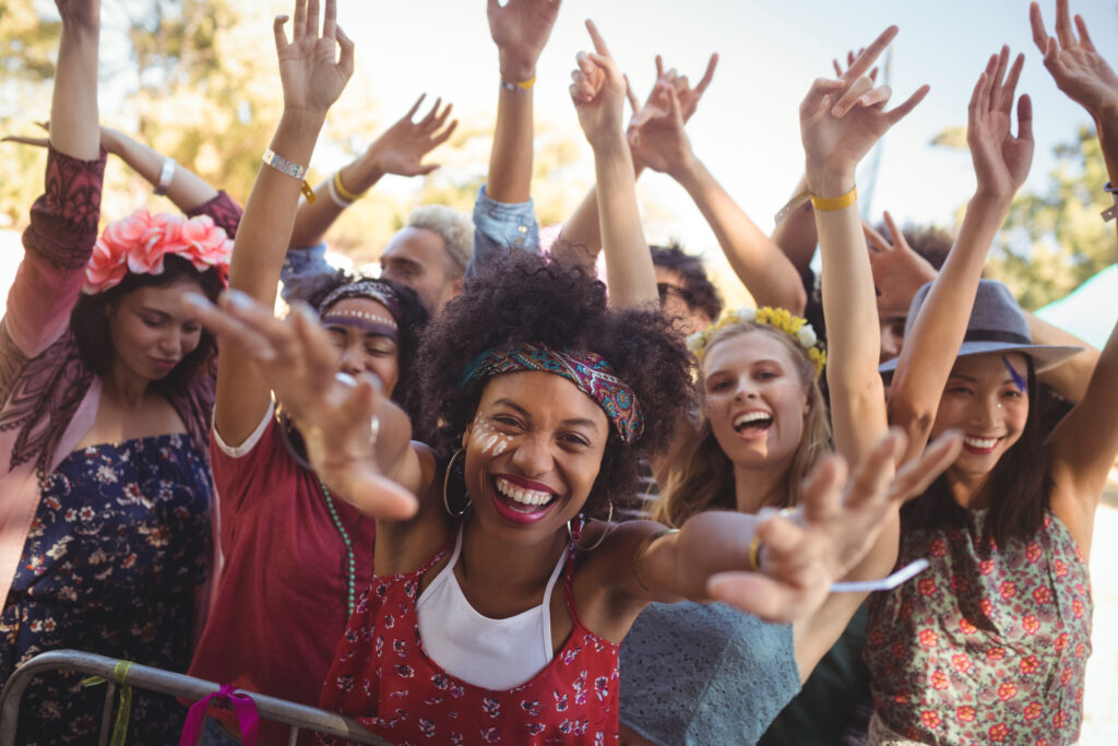 Portrait of cheerful woman enjoying at music festival